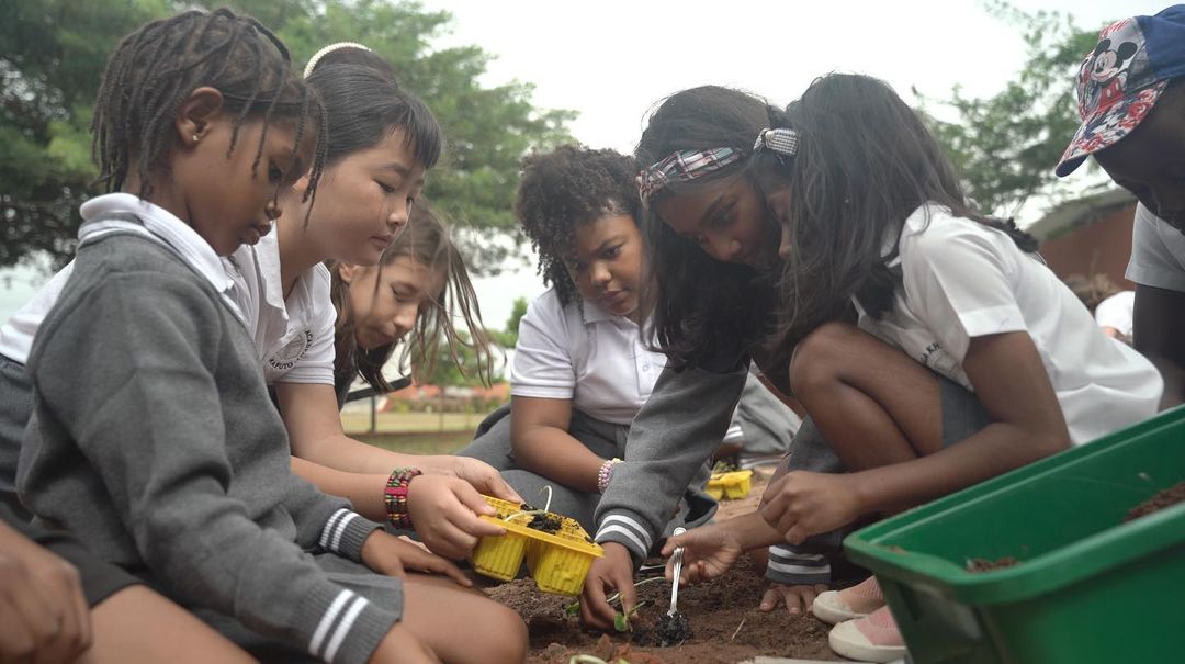 AKA Maputo students planting a seedling