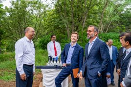 Prince Rahim Aga Khan and Prince Aly Muhammad Aga Khan at the Academy standing outside on the Academy's campus laughing with each other.